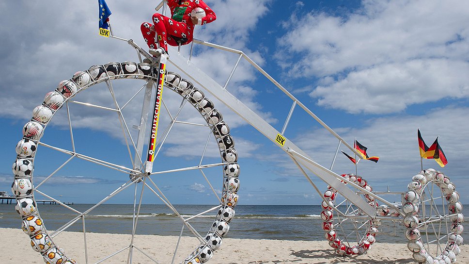 Трехколесный велосиипед, колеса которого сооружены из футбольных мячей