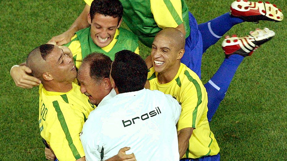 Главный тренер сборной Бразилии Луис Фелипе Сколари (в центре) обнимает Роналдо (слева) и Роберто Карлоса (справа) после того, как Роналдо забил второй гол во время финального матча на ЧМ—2002 с командой Германии
