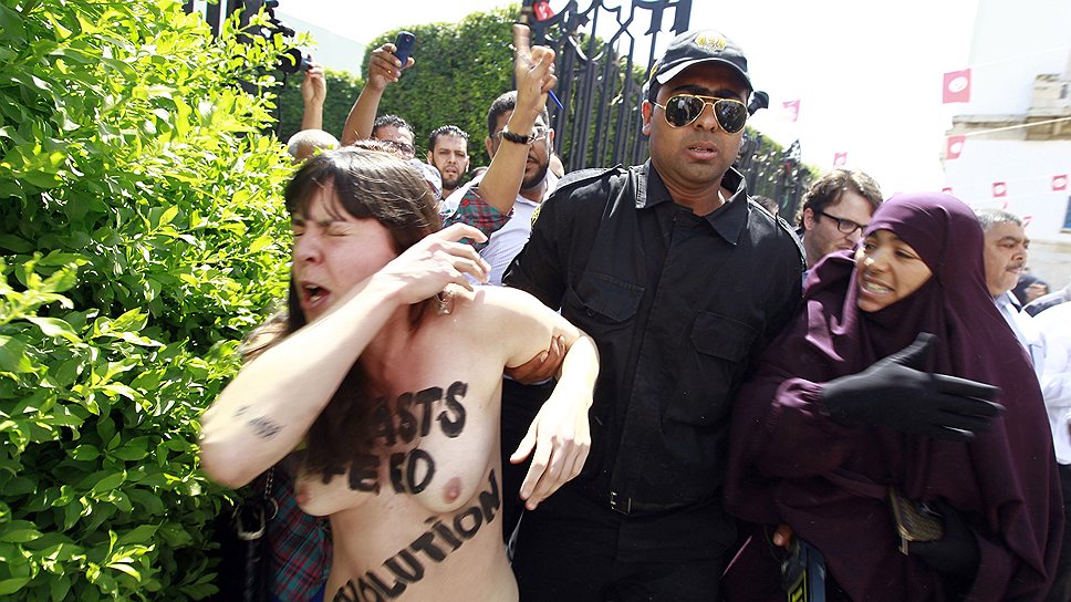 2013 год. Полицейские задерживают активистку из группы FEMEN во время акции протеста против ареста в Тунисе другой участницы FEMEN Амины Тайлер, которая ранее разместила в интернете свои обнаженные фотографии с антиисламскими надписями