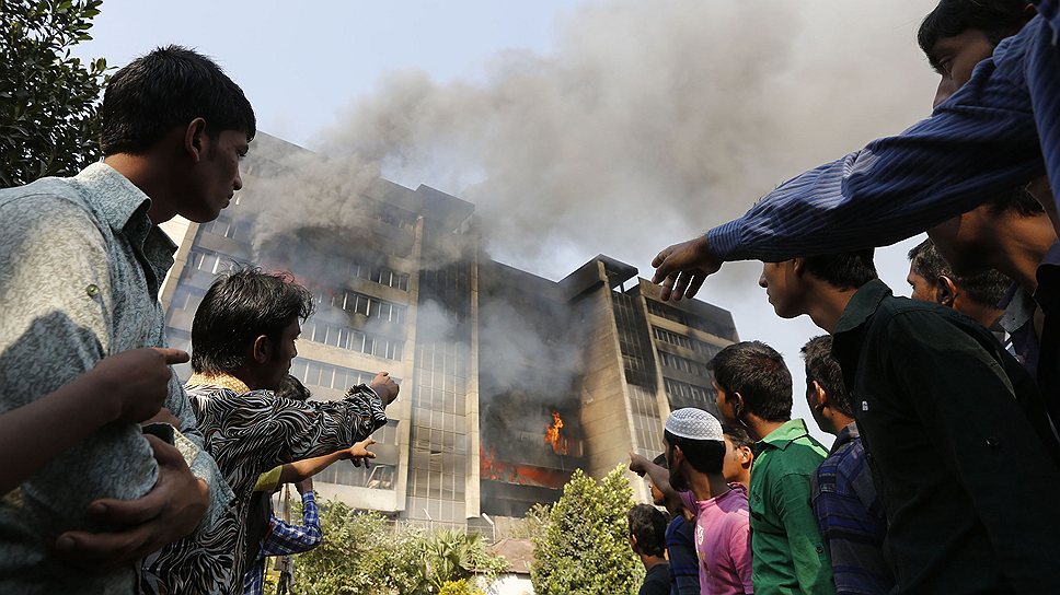 Работники толпятся перед швейной фабрикой Standard Group в Бангладеше, в котрой разгорелся огромный пожар