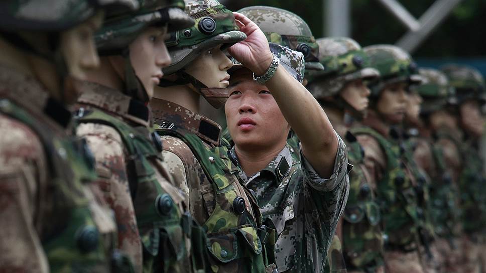 Солдат гонконгского гарнизона Народно-освободительной армии Китая поправляет манекены, служащие мишенями, перед тренировкой по стрельбе на авиабазе Шек Кон
