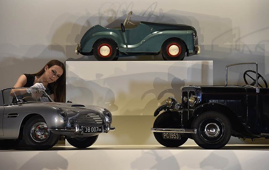 Куратор Королевской коллекции Анна Рейнольдс осматривает миниатюрный Aston Martin DB5, подаренный принцу Эндрю в 1966 году (Лондон, Великобритания)