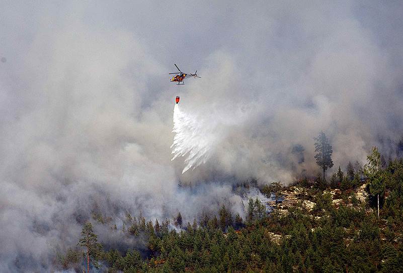 Вертолет тушит лесные пожары в центральной Швеции