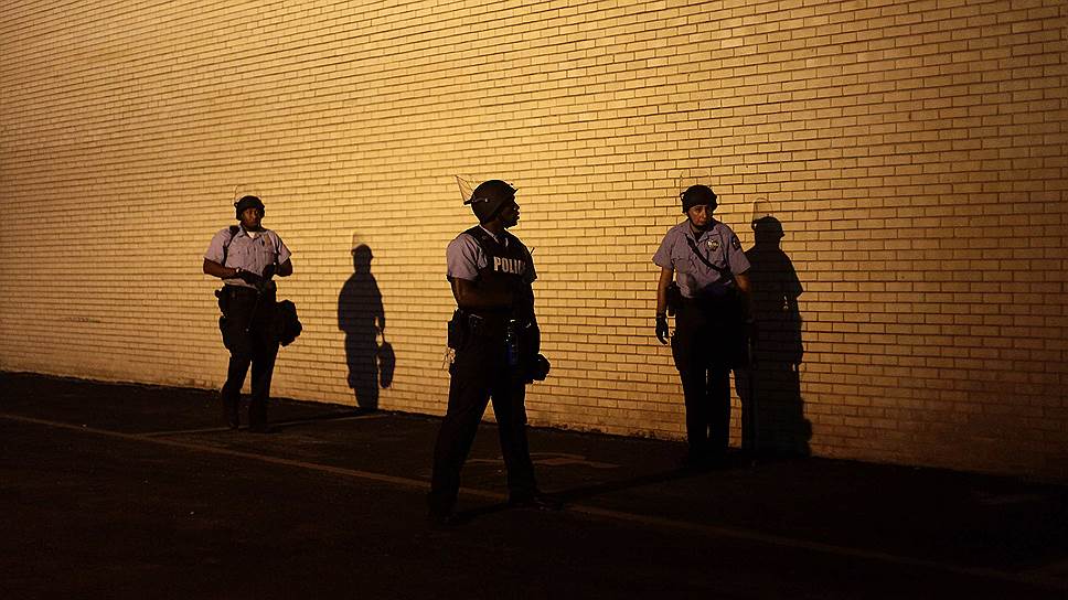 Сотрудники полиции наблюдают за демонстрантами в Фергюсоне, штат Миссури