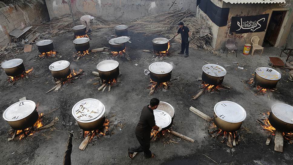 Бахрейнские мужчины готовят угощенья из риса, мяса и овощей, которые являются частью шиитской традиции во время исламского месяца Мухаррам