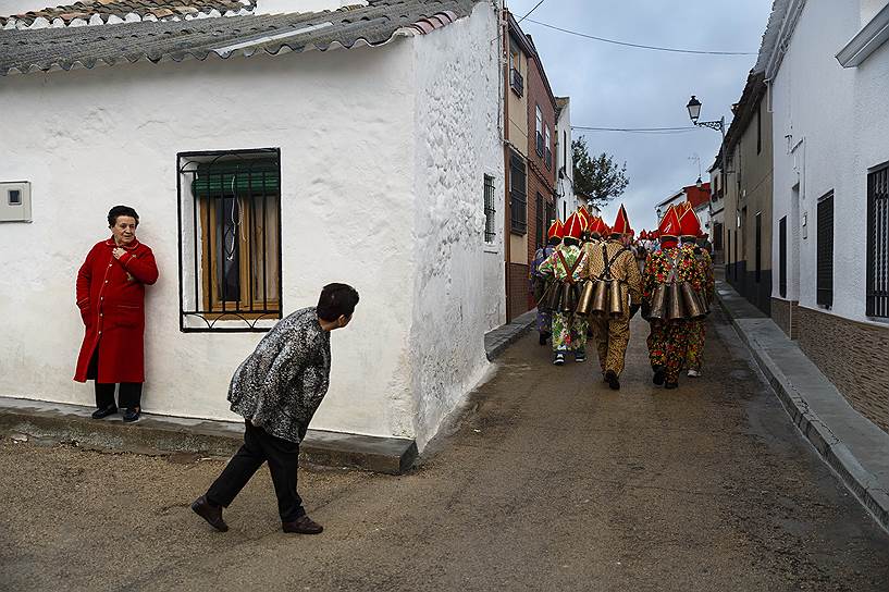 Альмонасид-дель-Маркесадо, Испания. Женщина смотрит вслед участникам парада во время традиционного фестиваля Endiablada