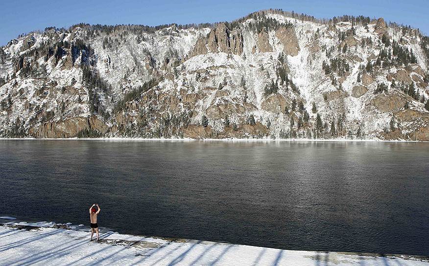 Дивногорск, Россия. Член клуба зимнего плавания разогревается перед заплывом по Енисею в 20-градусный мороз