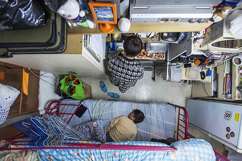 Гонконг, Китай. Женщина с ребенком в комнате площадью 5.5 квадратных метров (60 кв. футов), которую они снимают за 487 долларов США в месяц
