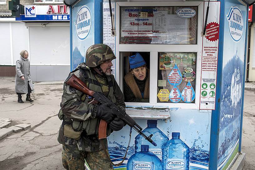 Донецк, Украина. Вооруженный человек, укрывающийся за киоском, во время «антитеррористических учений»