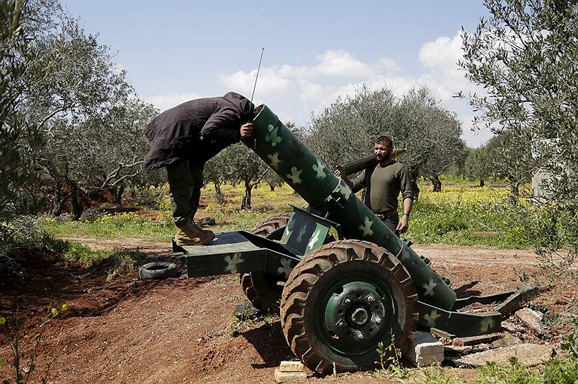 Идлиб, Сирия. Сирийский повстанец осматривает пушку возле линии фронта 
