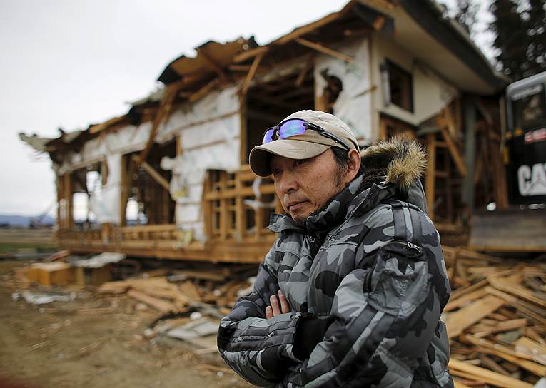 Такаюки Уэно возле своего дома в Минамисоме, который был разрушен в результате цунами. Местным жителям разрешено посещать свои дома раз в месяц, но категорически запрещено оставаться там. Всего стихийное бедствие полностью или частично разрушило свыше 400 тыс. домов
