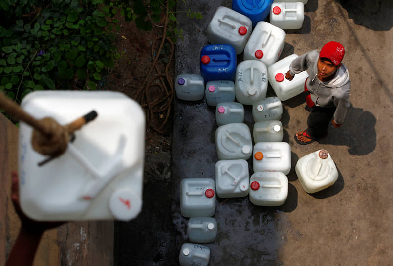 Почти 3 млрд человек во всем мире лишены возможности помыть руки под проточной водой &lt;br>
На фото: жители Куала-Лумпура поднимают канистры с чистой водой 

