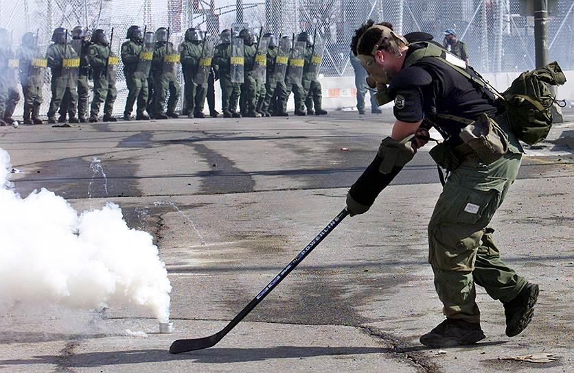 Апрель 2001 года. Протесты против Саммита Америк в Канаде. Демонстрант, отбрасывающий газовую гранату с помощью хоккейной клюшки