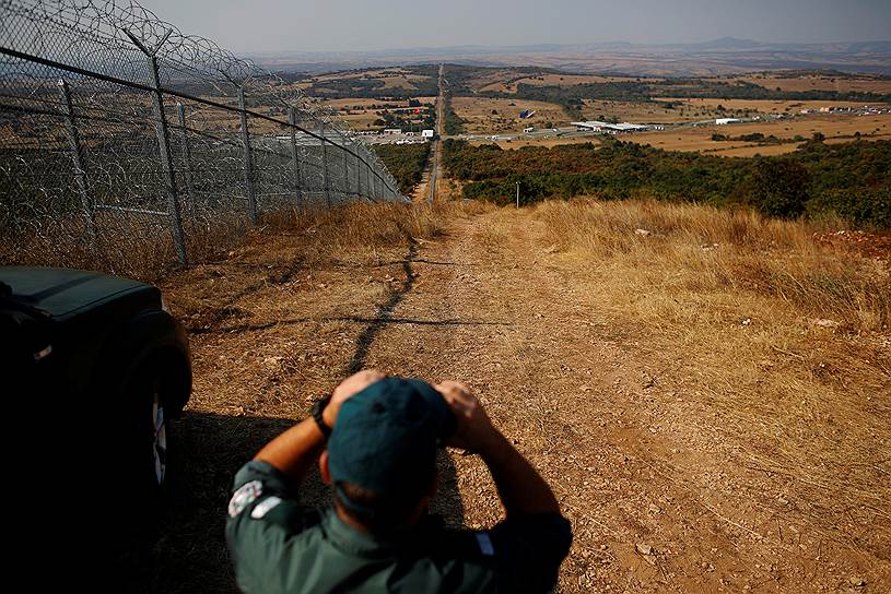 Лесово, Болгария. Полицейский на границе между Болгарией и Турцией, которая отделена забором с колючей проволокой 