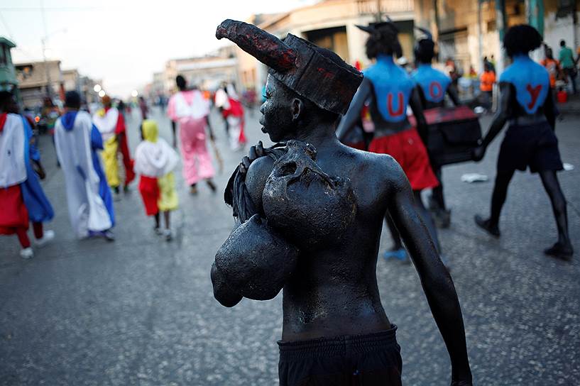 Порт-о-Пренс, Гаити. Участник карнавала несет два черепа 