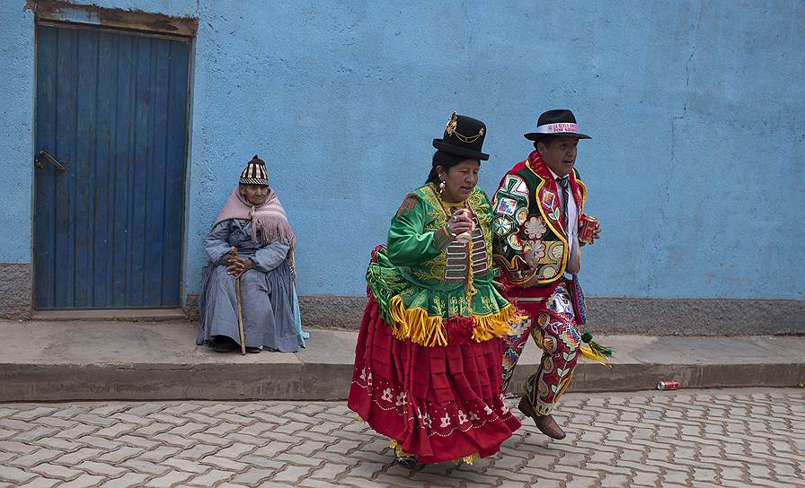 Какиавири, Боливия. Местные жители в традиционных костюмах танцуют перед началом шествия в Андах 
