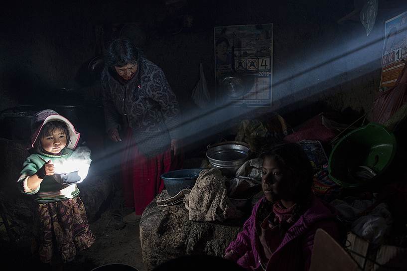 Озеро Титикака, Перу. Девочка держит кастрюлю с приготовленной едой