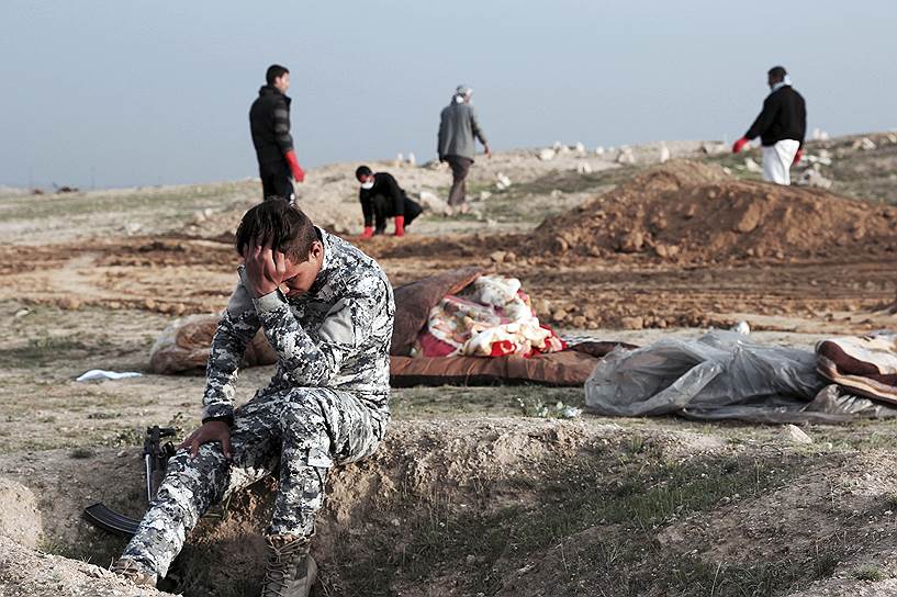 Мосул, Ирак. Иракский полицейский во время раскопок массового захоронения, которое организовали террористы «Исламского государства» (запрещено в РФ)
