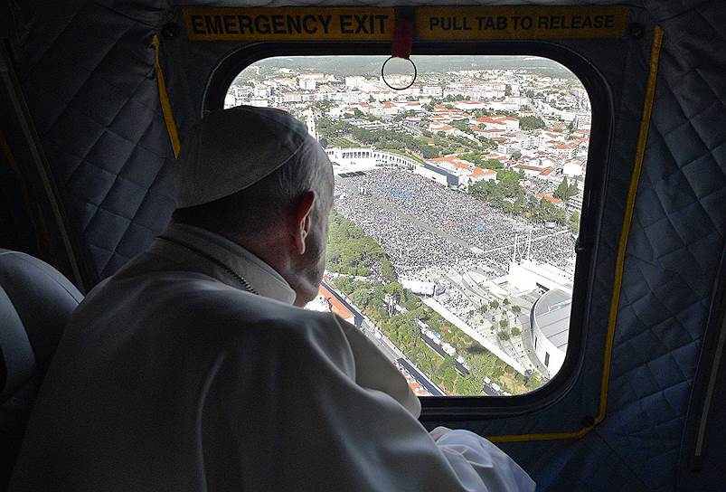 Фатима, Португалия. Папа римский Франциск наблюдает из вертолета за паломничеством к месту явления Девы Марии трем детям, которое произошло сто лет назад