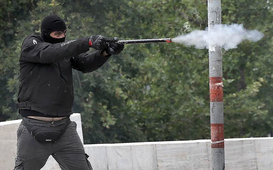Афины, Греция. Демонстрант выпускает снаряд в полицию во время 24-часовой всеобщей забастовки против принимаемых правительством мер жесткой экономии

