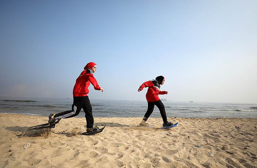 Александрия, Египет. Спортсменки-олимпийцы тренируются в снегоступах на пляже