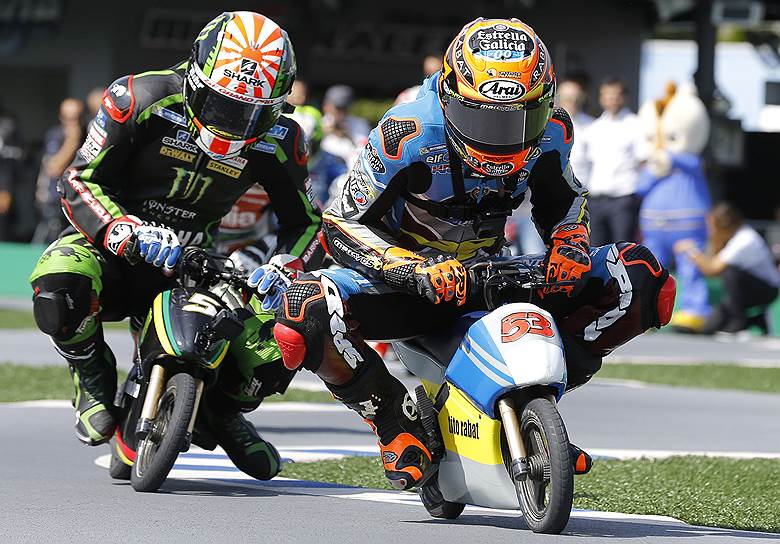 Токио, Япония. Мотогонщики Тито Рабат (справа) и Йохан Зарко участвуют в заезде на мини-мотоциклах в преддверии Гран-при Японии 