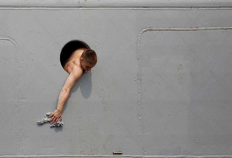 Манила, Филиппины. Российский моряк чистит корабль «Адмирал Виноградов» во время стоянки в порту