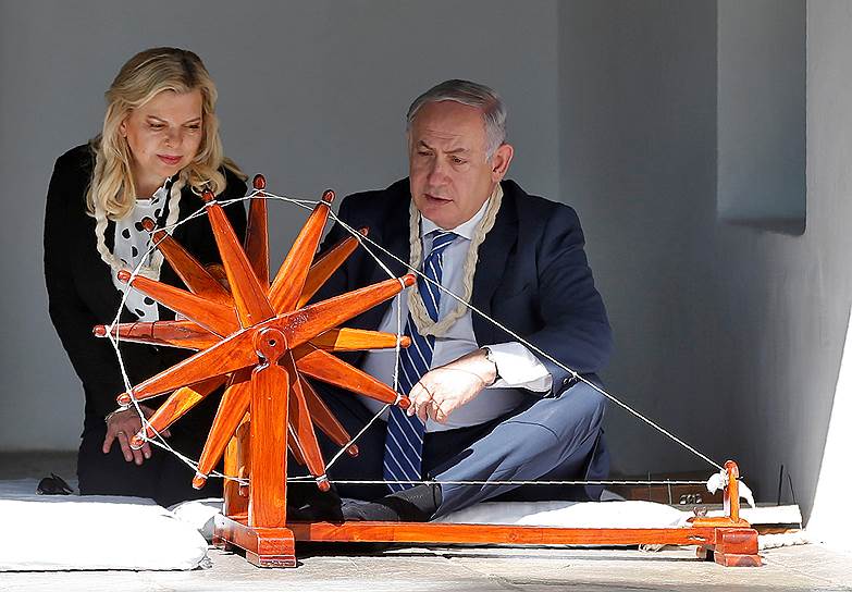 Ахмадабад, Индия. Премьер-министр Израиля Биньямин Нетаньяху и его супруга Сара наматывают хлопок на прядильное колесо во время посещения ашрама Сабармати 
