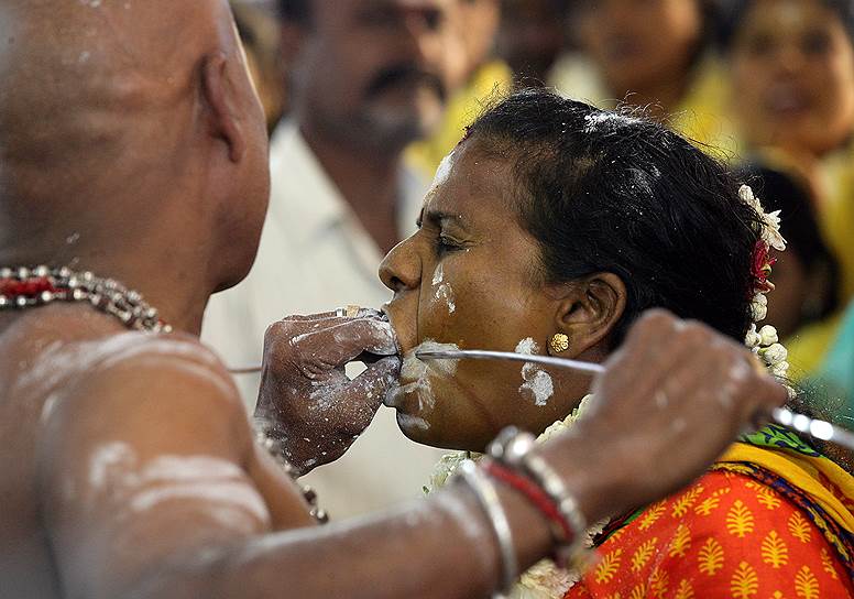 Ченнай, Индия. Женщине прокалывают щеки вертелом в рамках индуистского обряда