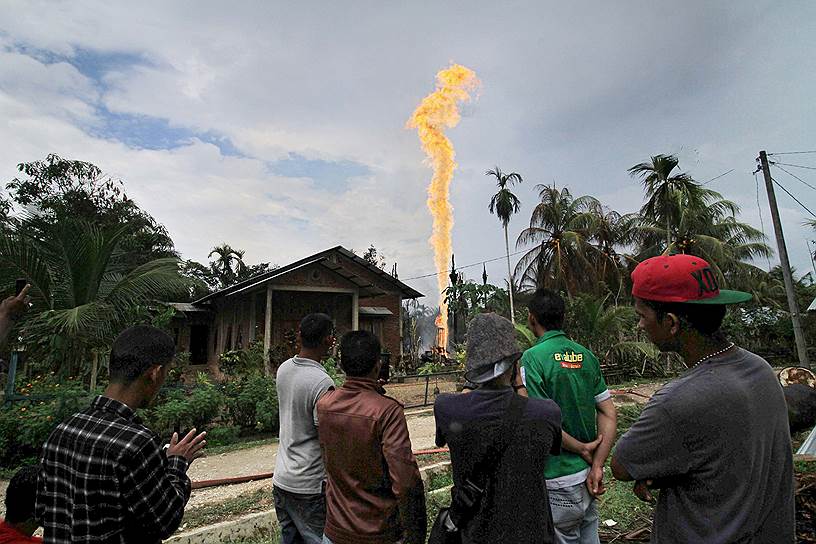 Провинция Ачех, Индонезия. Местные жители наблюдают за нелегальной нефтяной скважиной