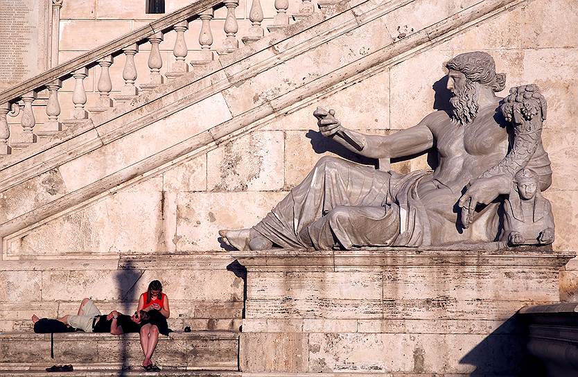 Рим, Италия. Туристы отдыхают у статуи на вершине Капитолийского холма