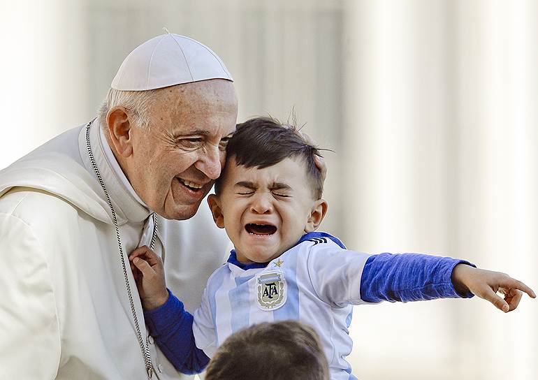 Площадь святого Петра, Ватикан. Папа римский Франциск общается с ребенком 