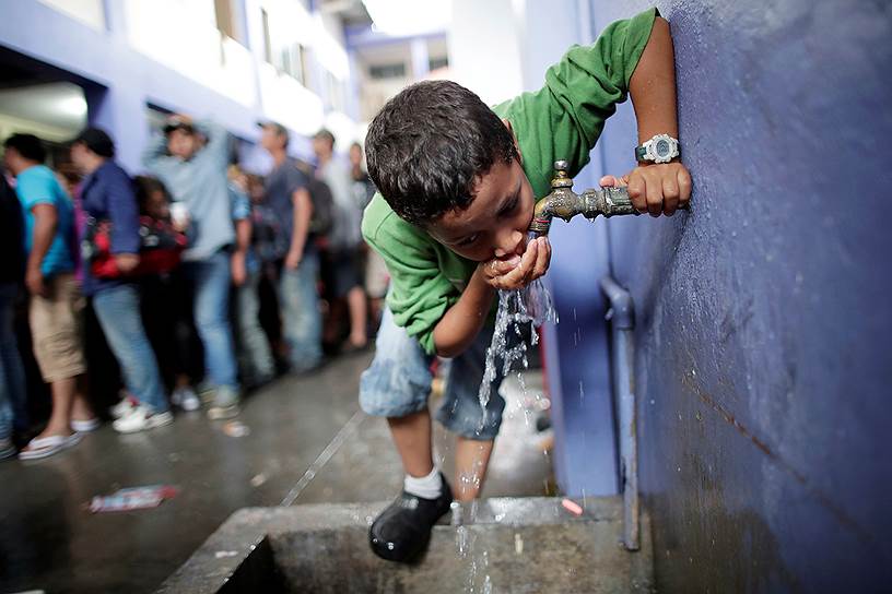 Текун-Уман, Гватемала. Беженец из Гондураса пьет воду на улице на пути в США возле границы с Мексикой