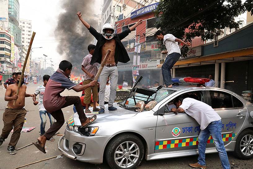 Дакка, Бангладеш. Активисты Националистической партии Бангладеш (BNP) громят полицейскую машину во время столкновений