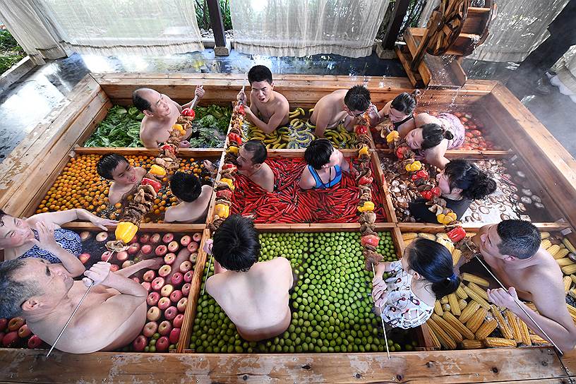Ханчжоу, Китай. Местные жители едят приготовленную на гриле еду во время купания