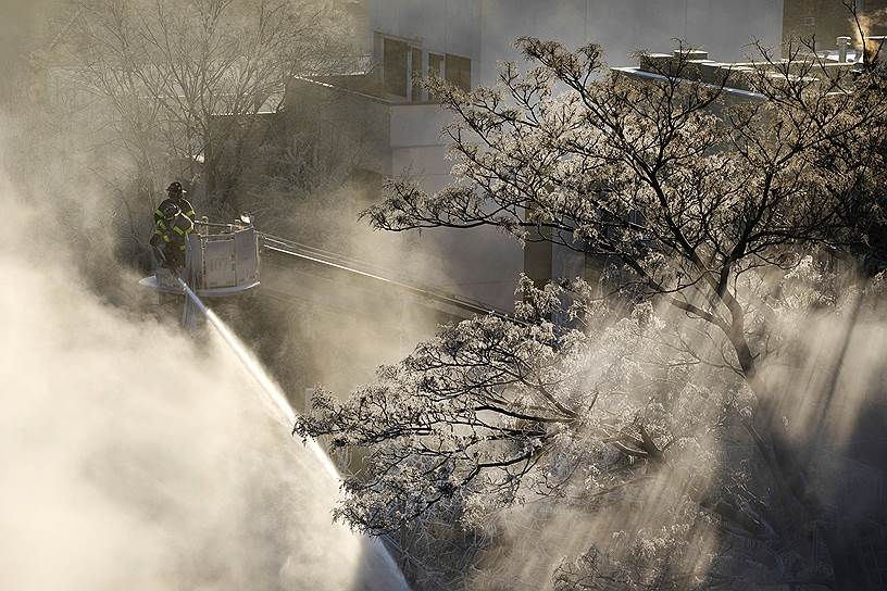 30 января на значительную часть территории США обрушились сильные холода, ряд американских авиакомпаний  отменил более 3,6 тыс. рейсов. Больше всего пострадало авиасообщение в Чикаго (штат Иллинойс) - отменены не менее 1,4 тыс. рейсов&lt;br>
На фото: пожарные тушат пожар в одном из зданий в Нью-Йорке 