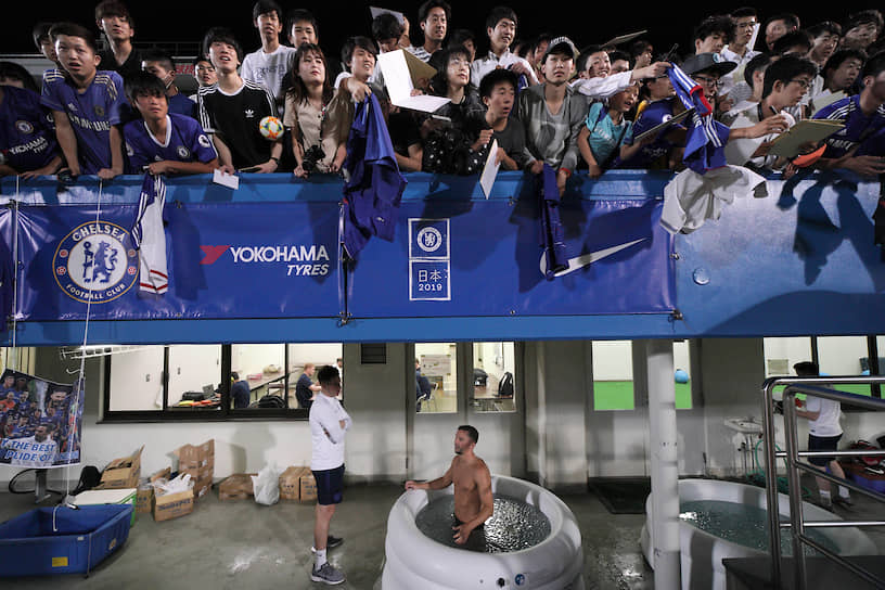 Иокогама, Япония. Английский футболист Дэнни Дринкуотер (внизу в бассейне) после тренировки перед матчем 