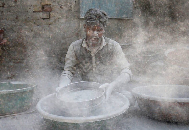 Ахмедабад, Индия. Рабочий на фабрике изготавливает порох для петард