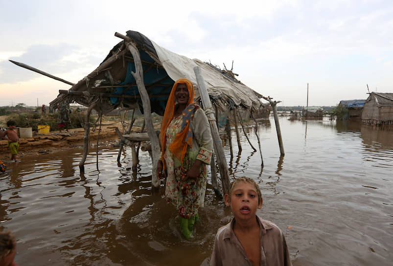 Карачи, Пакистан. Женщина со своим ребенком после наводнения