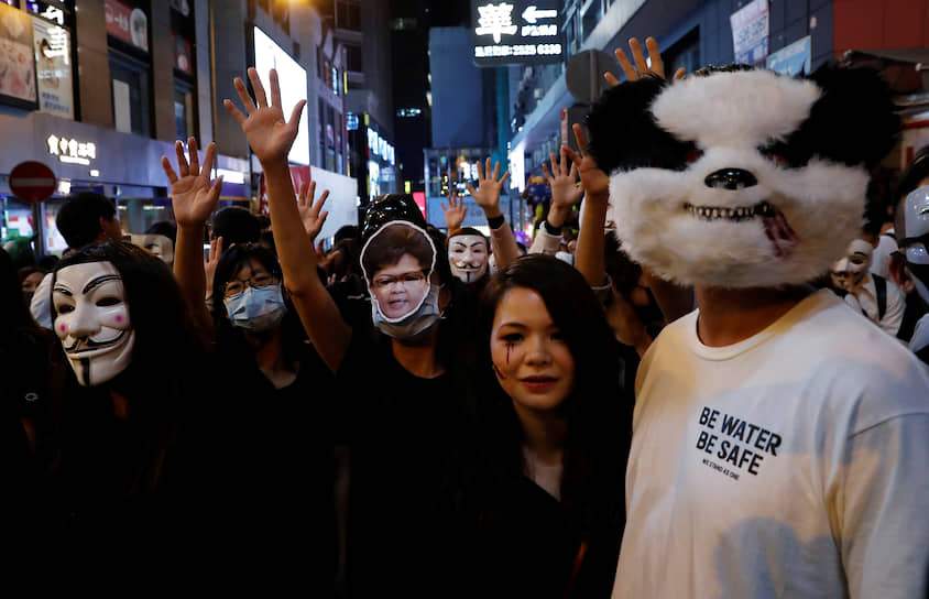Гонконг, Китай. Участники антиправительственной акции в карнавальных костюмах 
