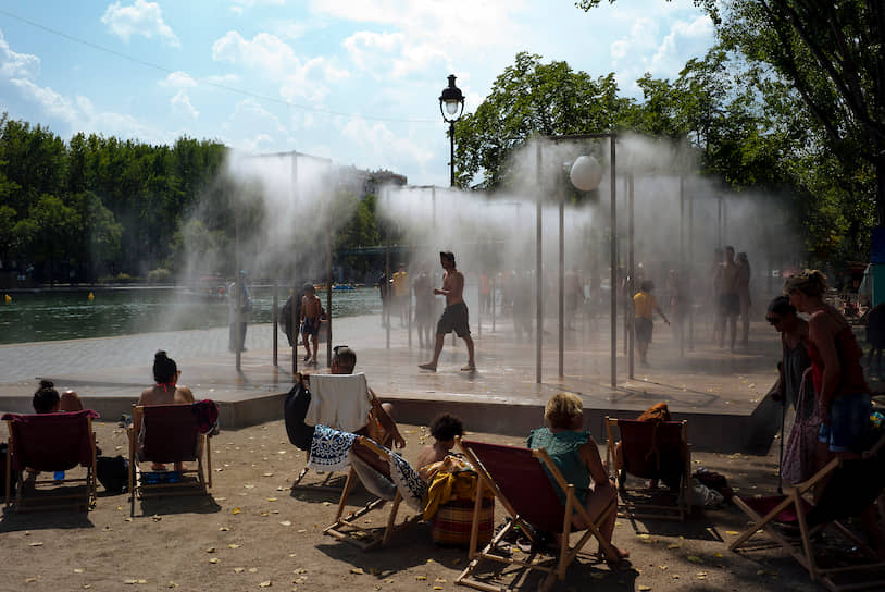 Париж, Франция. Люди спасаются от жары в фонтанах