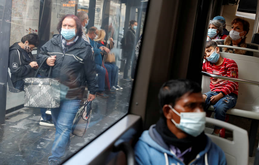 Рим, Италия. Пассажиры автобуса и прохожие в масках. Власти вводят новые ограничения из-за всплеска заболеваемости COVID-19 