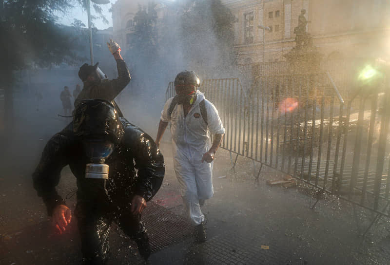 Сантьяго, Чили. Полицейские используют водометы для разгона протестующих  