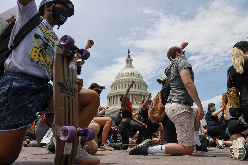 Изначально мирные протесты быстро вылились в беспорядки, грабежи магазинов, поджоги, погромы и столкновения с полицией
&lt;br>На фото: участники акции протеста в Вашингтоне преклоняют колено в память о Джордже Флойде