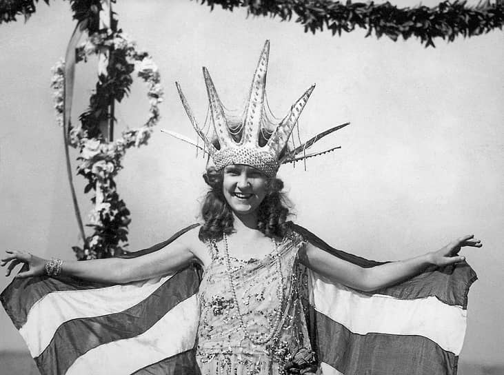 Первая победительница конкурса «Мисс Америка» Маргарет Горман в короне Статуи свободы и полосатой накидке, символизирующей американский флаг