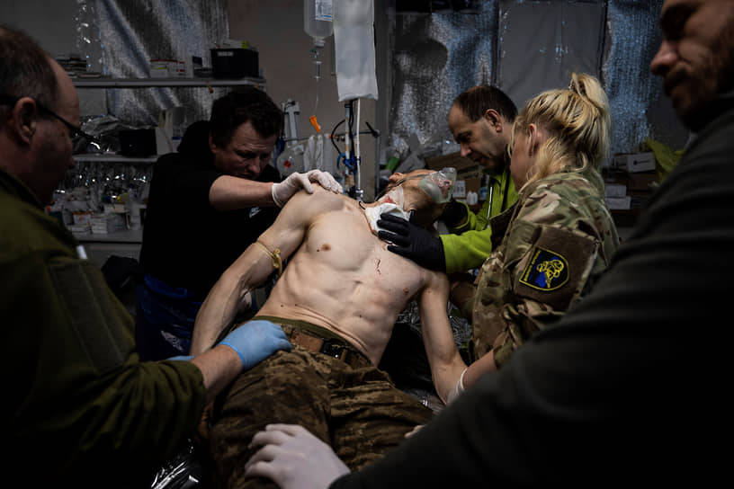 Украинские военные медики оказывают помощь раненому в полевом госпитале под Бахмутом