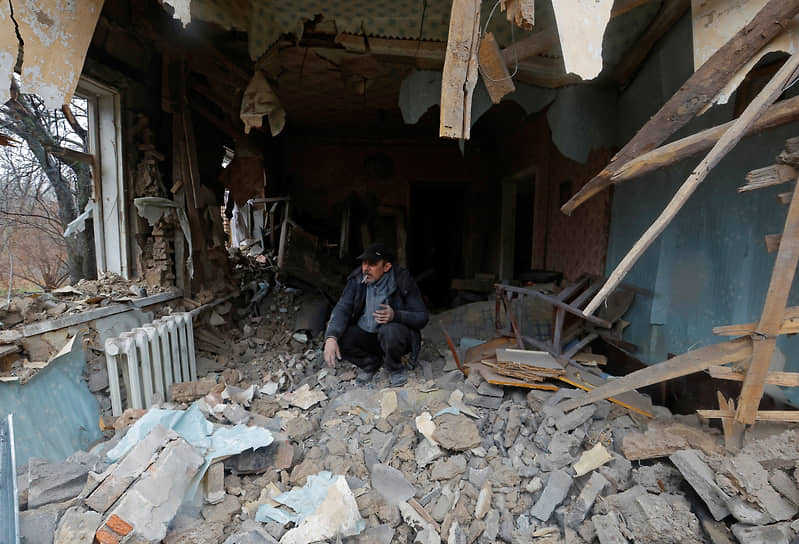 Житель Донецка курит в своем разрушенном доме
