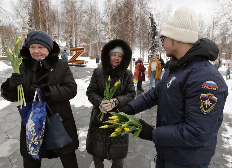 Москва. Волонтер раздает цветы женщинам в парке «Зарядье»