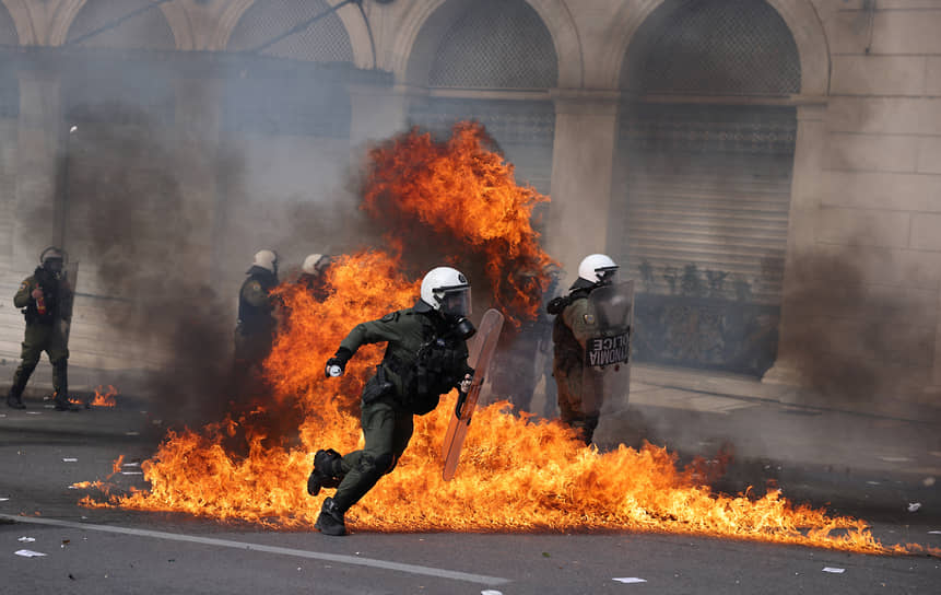 Афины, Греция. Участники забастовки против несоблюдения стандартов безопасности в общественном транспорте бросают «коктейли Молотова» в полицейских
