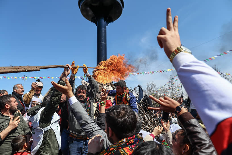 Сторонники прокурдской Демократической партии народов выкрикивают лозунги у костра на митинге в рамках празднования Навруза в Диярбакыре